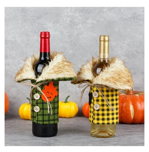 Detail of plaid wine bottle covers with faux fur collars and buttons for festive decor