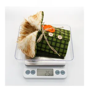 Halloween bottle cover detail with green plaid fabric, faux fur trim and pumpkin patch