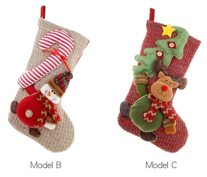 Detail of knitted Christmas stockings with 3D snowman and elk characters on white background