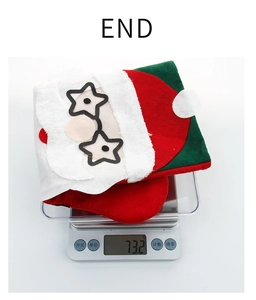 Détail montrant le poids d'une chaussette de Noël avec broderie Père Noël sur une balance