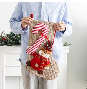 Close-up of burlap Christmas stocking featuring a 3D snowman and candy cane detail