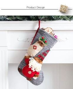 Detail of grey knitted Christmas stocking with 3D Santa doll on a white fireplace
