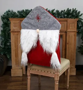Close-up of a red Christmas gnome chair cover with long white beard and star embroidery