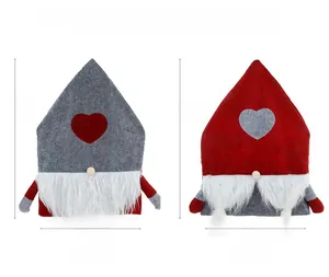 Detail of Nordic Christmas gnome chair covers in grey and red plush with dimensions 65x47cm