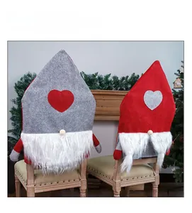 Detail of Gnome Christmas chair covers with plush beards and heart patterns in red and gray