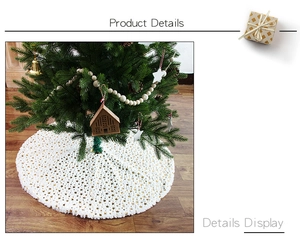 Detailed view of white plush Christmas tree skirt featuring golden star patterns decoration
