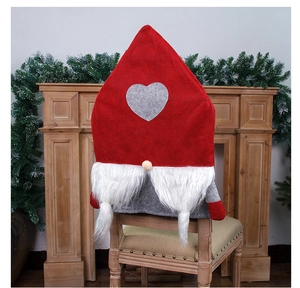 Detail of Christmas gnome chair cover with red hat and white beard on a wooden chair