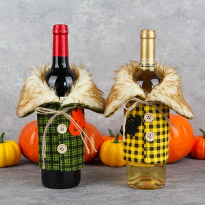 Halloween wine bottle covers in green and yellow plaid with faux fur and pumpkin decor