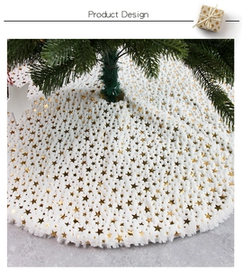 Detailed view of white plush Christmas tree skirt featuring golden star patterns