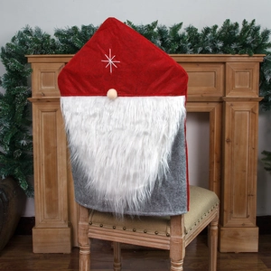 Christmas gnome chair cover with red star hat and long white beard on a wooden chair
