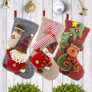 Three knitted Christmas stockings with 3D Santa, snowman, and reindeer on wood