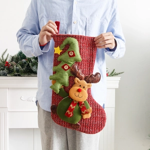 Large red knitted Christmas stocking with 3D reindeer and green tree decoration