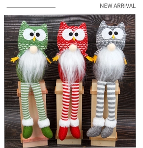 Three-piece Christmas owl gnome set with striped legs and knit hats on wooden blocks
