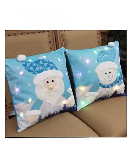 Detail of Christmas pillow covers featuring LED lights, Santa and Snowman embroidery