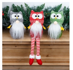 Three Christmas owl gnomes in red, green, and grey on a wooden festive background