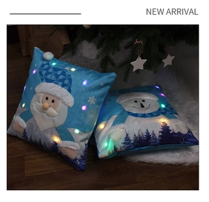 Detail of Christmas pillow cases with LED lights featuring Santa and Snowman embroidery