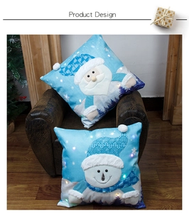 Close-up of LED Christmas pillow covers with Santa and Snowman on a leather sofa