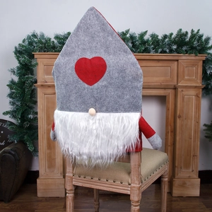 Nordic Christmas gnome chair cover with red heart and white beard on wooden chair