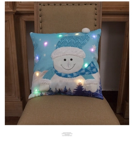 Close-up of LED glowing Christmas pillow cover featuring a 3D snowman with blue scarf