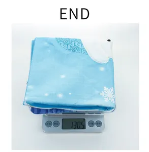 Detail shot of light blue snowflake pillowcase weighing 130.5 grams on a digital scale