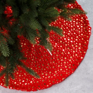 Red plush Christmas tree skirt with gold foil star patterns for holiday decorations