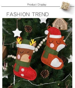 Detail of felt Christmas stockings featuring reindeer and fox motifs on a Christmas tree