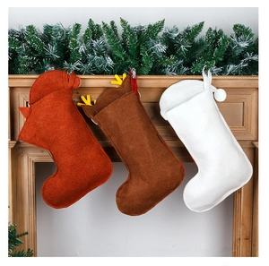 Three felt Christmas stockings in red, brown and white hanging on a wooden fireplace