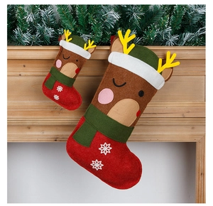 Close-up of felt Christmas stockings with reindeer design and snowflake embroidery