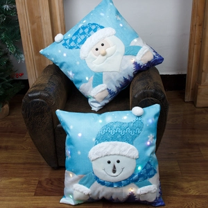 LED lighted Christmas pillow covers with Santa and snowman 3D plush applique on brown chair