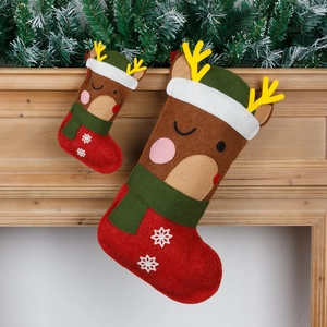 Cartoon reindeer felt Christmas stocking set with snowflake embroidery on wooden fireplace
