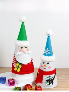 Detail of 3D Santa and Snowman felt gift bags with pom-pom accents for Christmas decor