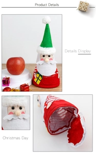 Detail of red Santa gift bag with green hat pompom and zip closure on the bottom