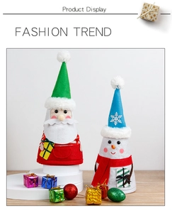 Detail view of Santa and Snowman wine bottle covers with knitted hats and embroidery