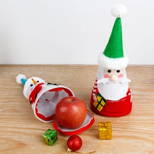 Christmas Santa and Snowman gift bags for candy or apples on a rustic wooden background