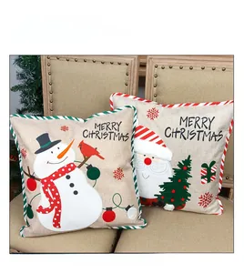 Close-up of linen Christmas pillowcases with Santa motifs and festive red piping trim