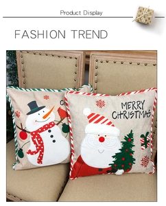 Close-up of linen Christmas pillow covers with Santa and Snowman embroidery details