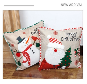Close-up of linen Christmas pillowcases with Santa and Snowman embroidery details