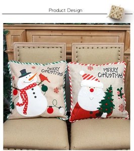 Detail of Christmas pillow covers with Santa and Snowman embroidery and piping