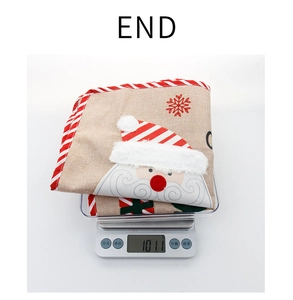 Close-up of linen Christmas pillow cover with Santa embroidery weighing 101.1g