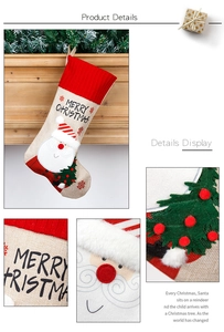 Detailed view of linen Christmas stocking with Santa embroidery and festive decorations