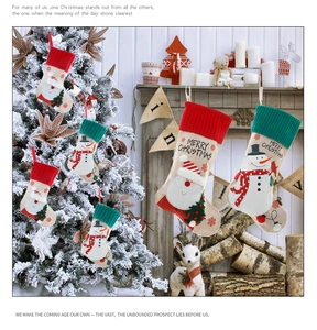 Close-up of linen Christmas stockings with Santa embroidery and Merry Christmas text