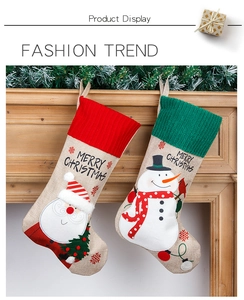 Detail of hanging burlap Christmas stockings with embroidered Santa and Snowman motifs
