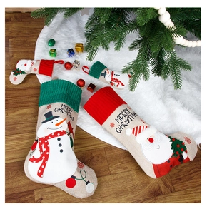 Close-up of linen Christmas stockings with embroidery and Merry Christmas text