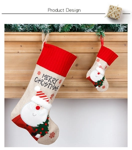 Linen Christmas stocking set with Santa embroidery hanging on a wooden fireplace mantle