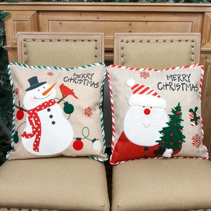 Linen Christmas pillow covers with Santa and Snowman embroidery on rustic chairs
