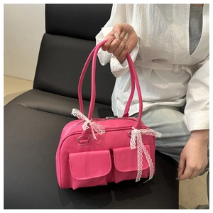 Detail of rose pink pillow bag with white lace bows and double front flap pockets