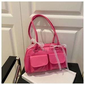 Detail of pink fashion pillow bag with white lace bows and symmetrical front pockets