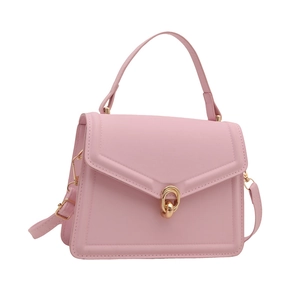 Elegant pink crossbody handbag with gold buckle and top handle on a clean white background