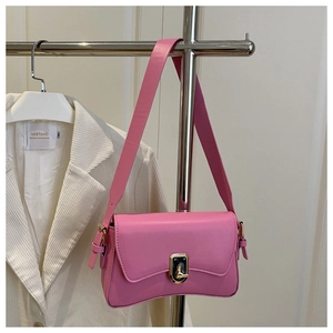 Detail view of pink underarm bag with curved bottom and golden turn-lock closure