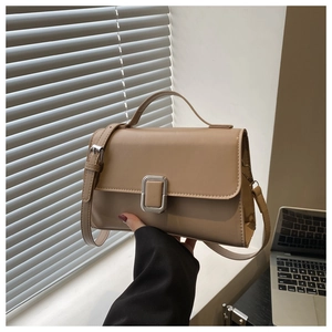 Detail of khaki leather handbag with silver square buckle and elegant top handle